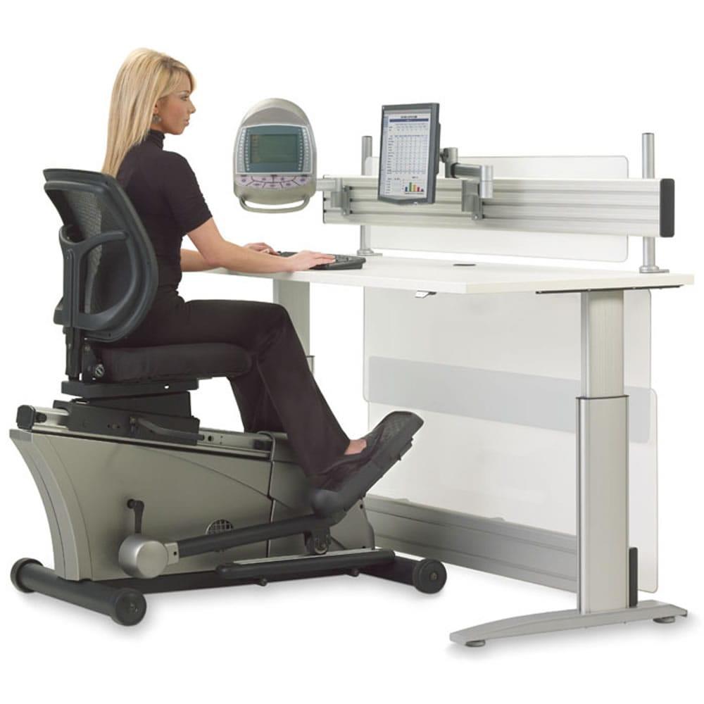 A woman sitting in a Hammacher Schlemmer Elliptical Machine Office Desk